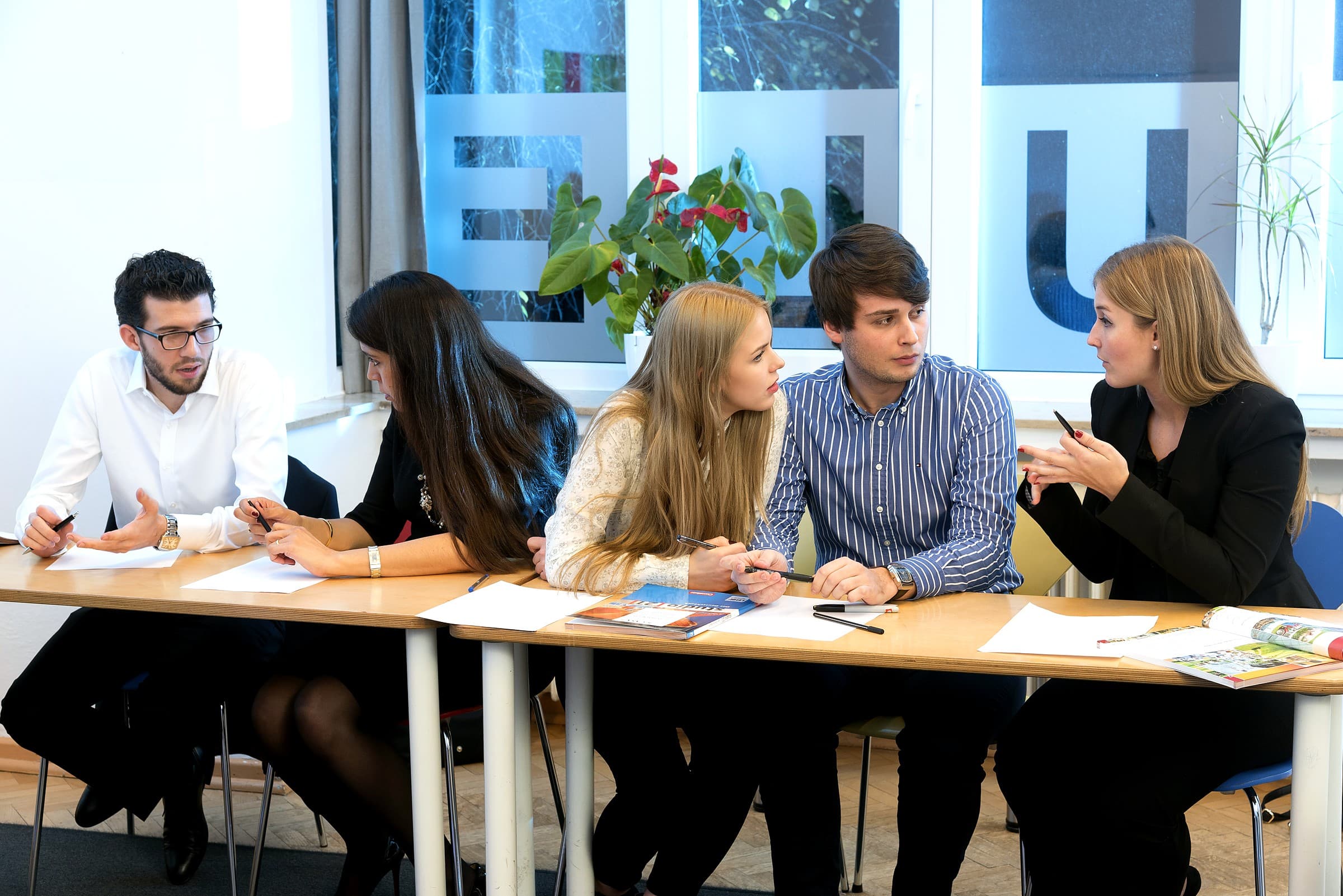 adult learners in a business German discussion at CASA