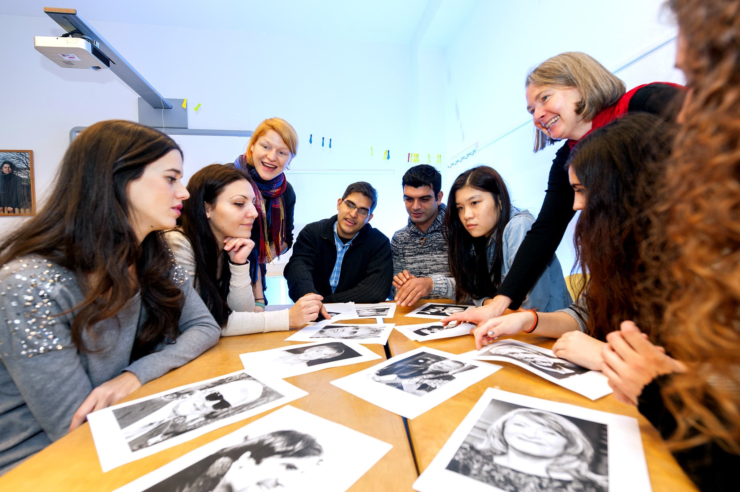 CASA learners and a teacher working together around a classroom table