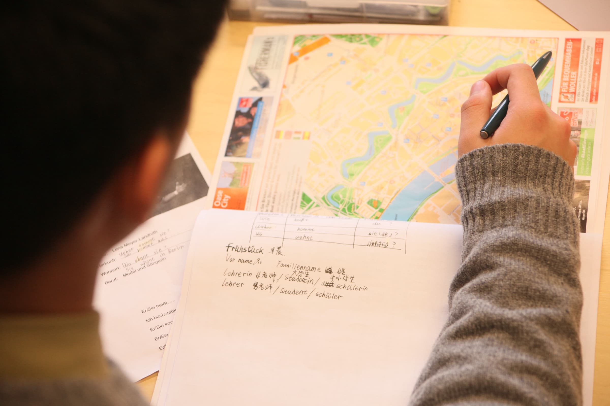 CASA learner notes beside a Bremen map during German practice