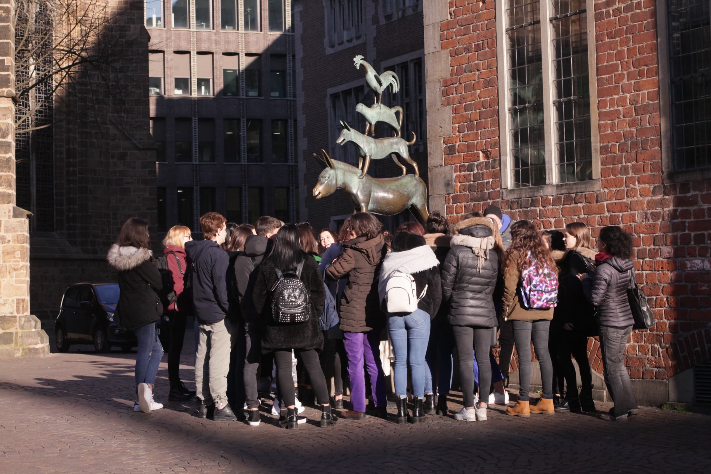 CASA group-course students gathered by the Bremen Town Musicians