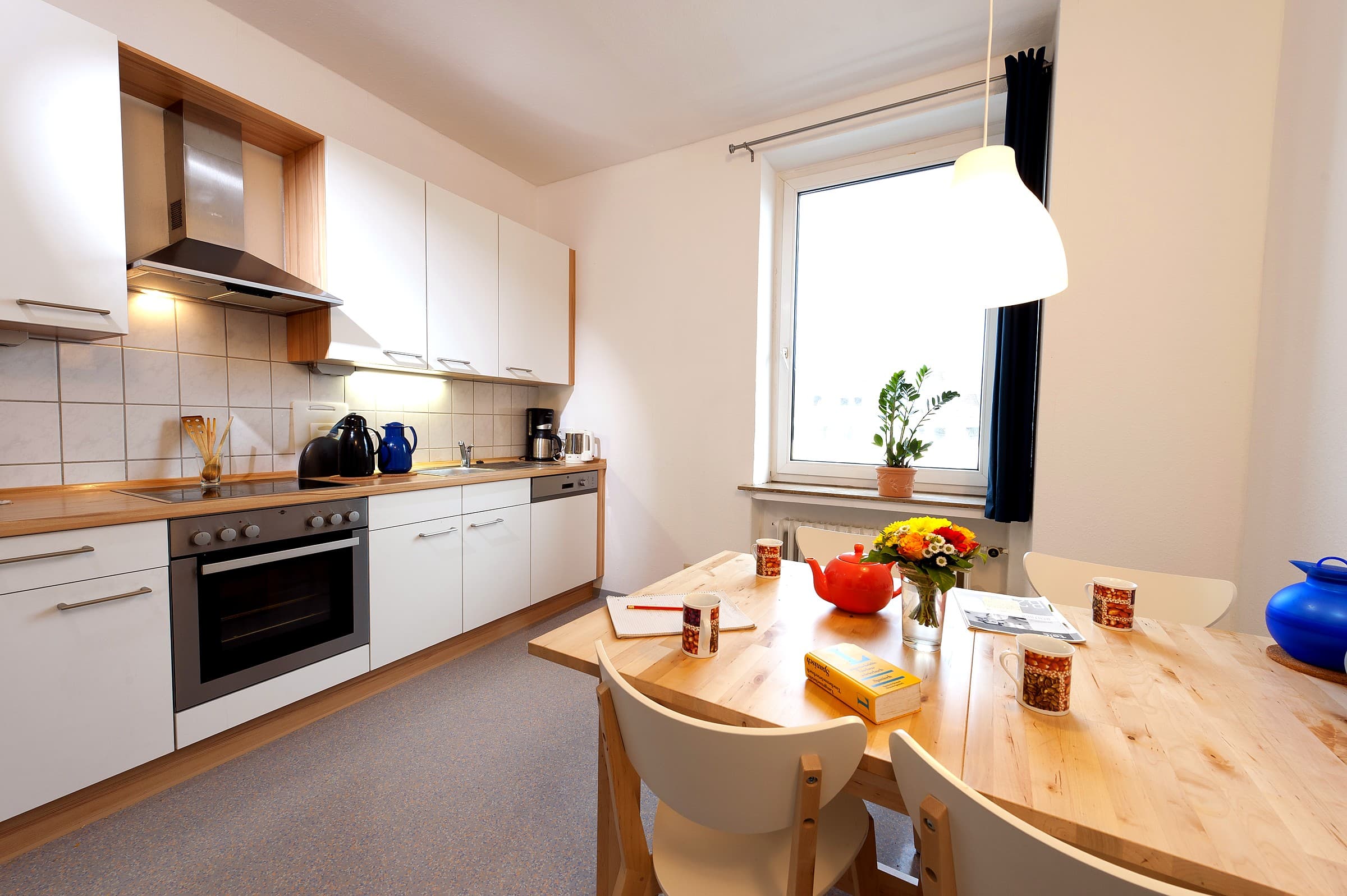 student accommodation kitchen with a table and study materials